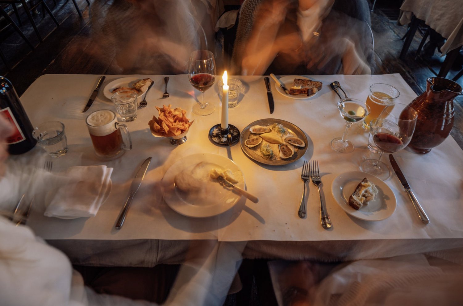 Dinner table with bread, beer and wine