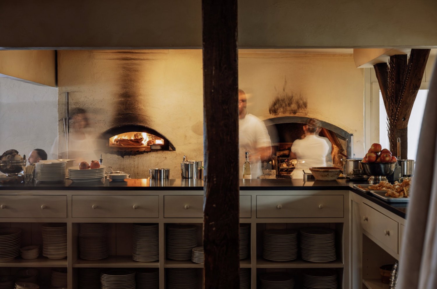 Long exposure photo of wood-fire oven and kitchen